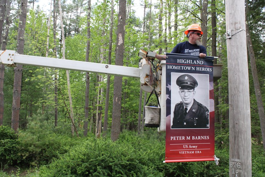 Bob Grim hangs Peter Barnes' banner